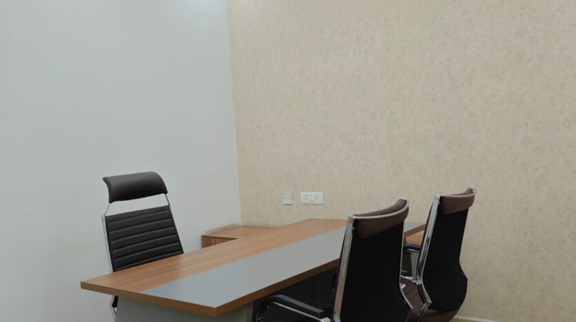 Private cabin with desk and seating in fully furnished office space for rent in Noida Sector 65